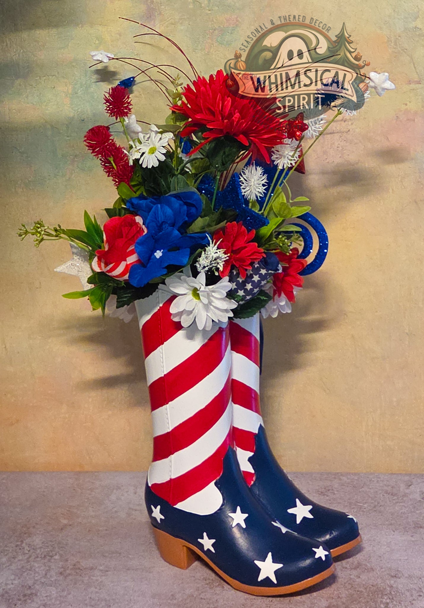 Decorative display with American flag-patterned boots holding a bouquet of red, white, and blue flowers.