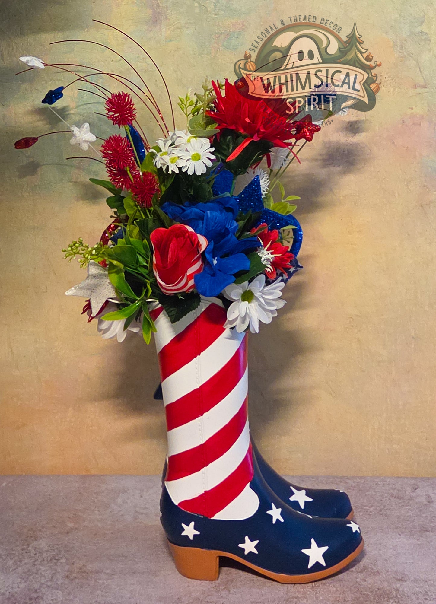 Decorative boot with American flag design filled with flowers, branded 'Whimsical Spirit'.