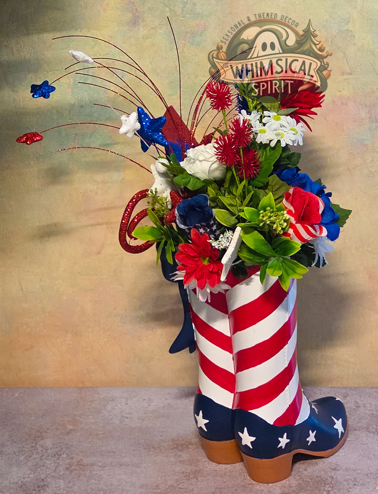 Decorative floral arrangement in a boot with American flag design on a textured background.