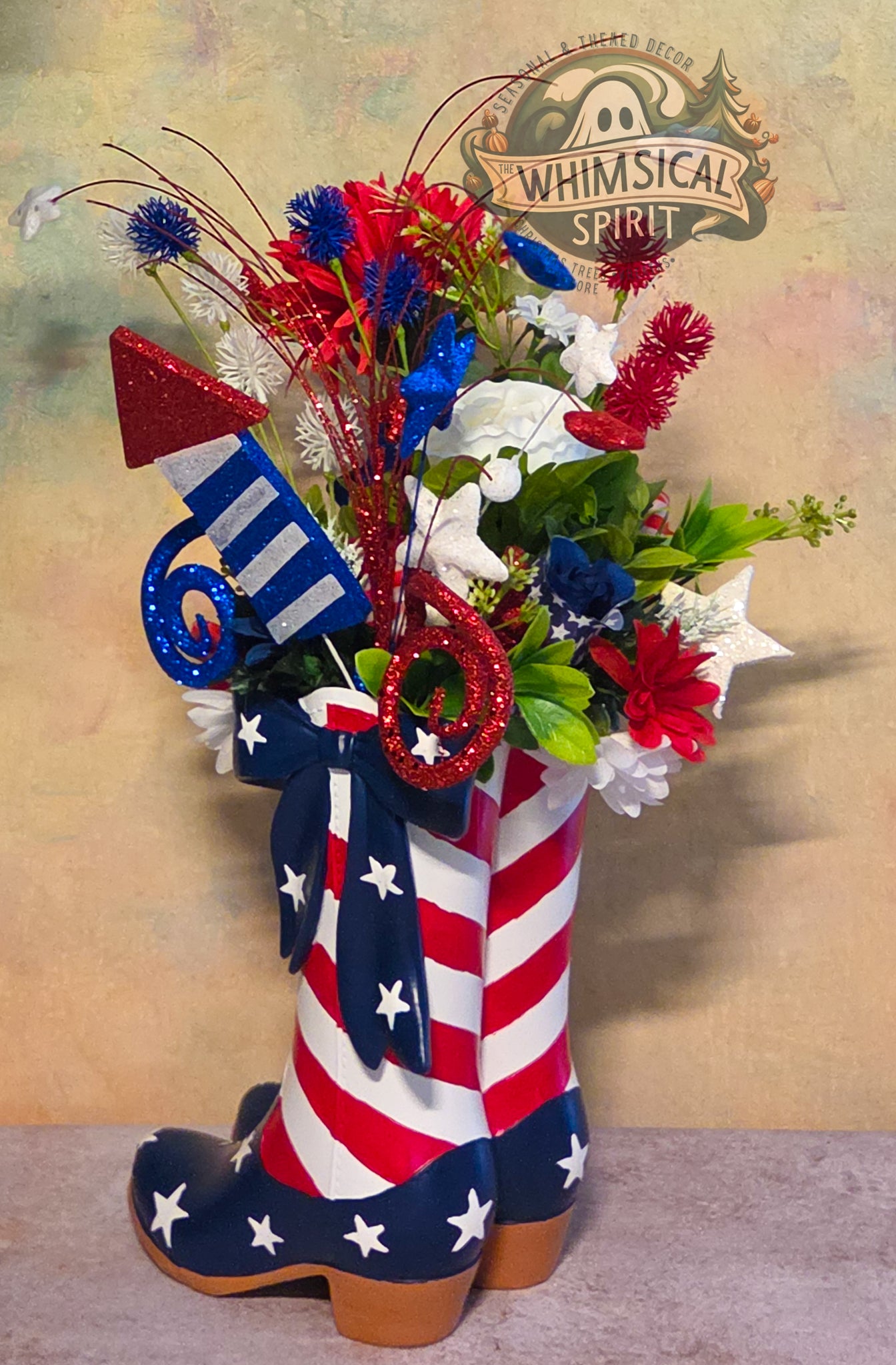 Decorative cowboy boot with American flag design filled with flowers, against a 'Whimsical Spirit' branded background.