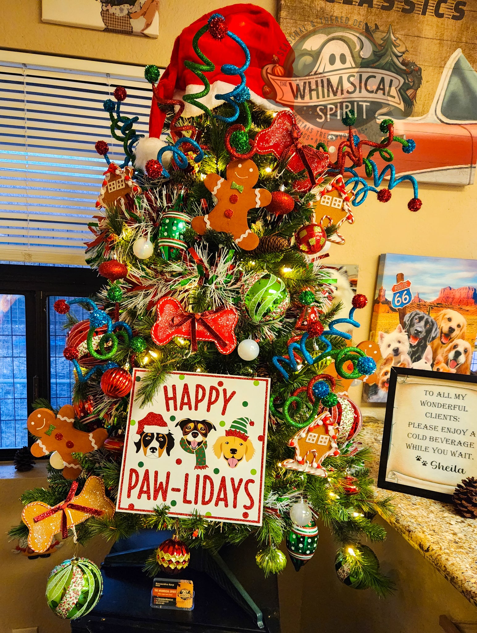 Custom pet-themed Christmas tree decorated with dog ornaments, gingerbread accents, colorful lights, playful ribbon sprays, and a Happy Paw-lidays sign.