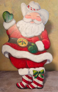 Sleigh Bells & Spurs Western Santa metal art featuring a waving Santa in a white cowboy hat, red suit, green mittens, and striped boots.