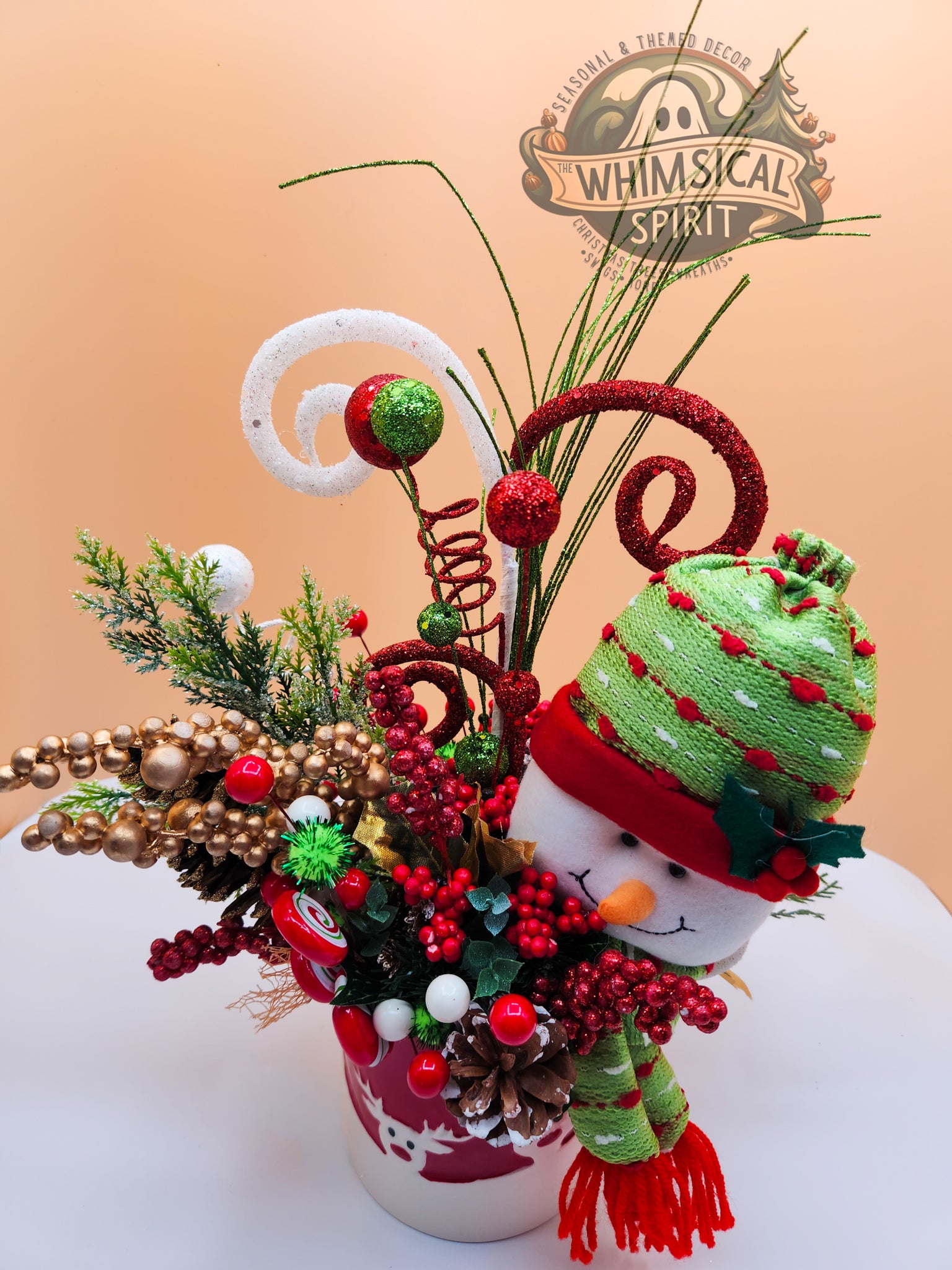 Decorative Christmas arrangement: 'Whimsical Spirit,' snowman, colorful ornaments, and festive decor.