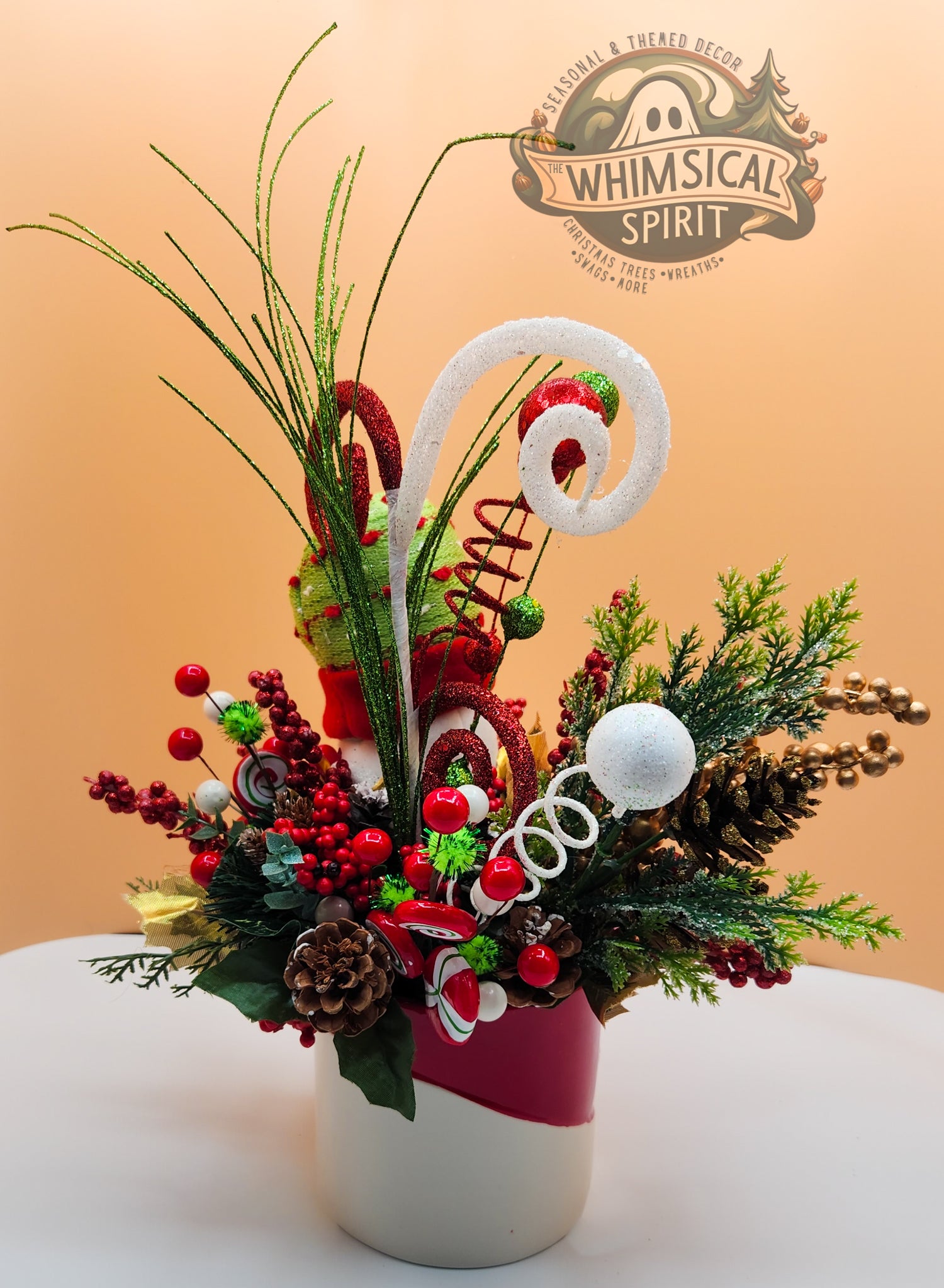 Christmas floral with candy canes and 'Whimsical Spirit' logo on beige, festive holiday arrangement.