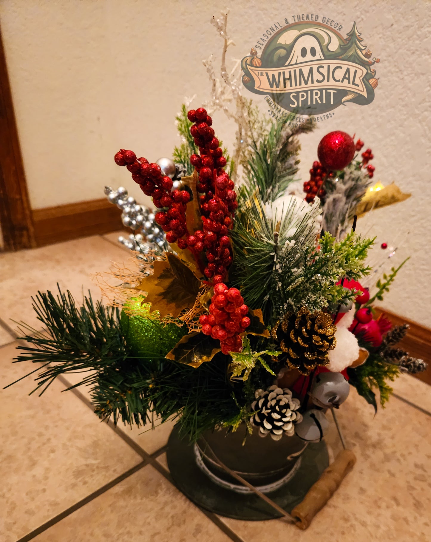 Snowy Gingerbread Harvest arrangement with red berries, greenery, and metal container