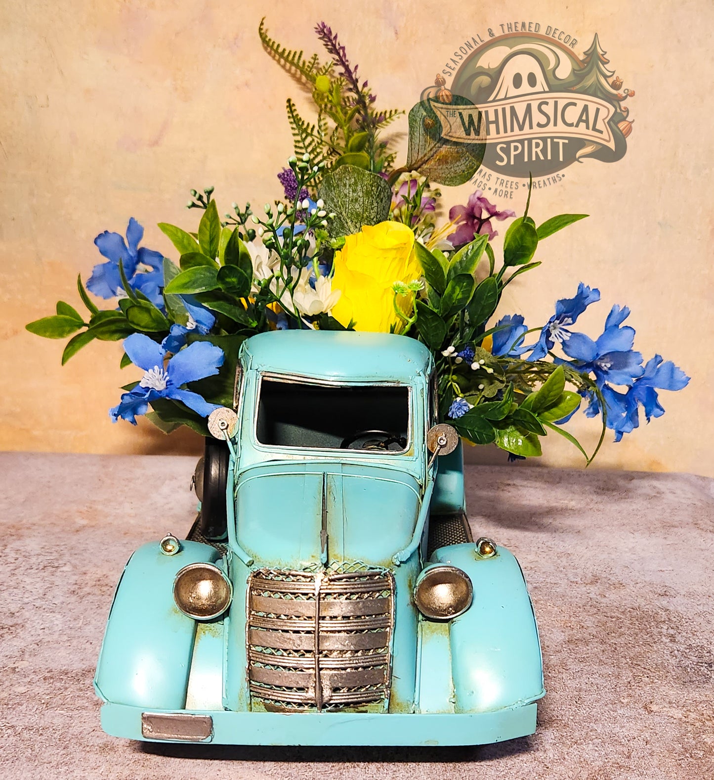 Vintage-style teal truck with flowers against a beige background with 'Whimsical Spirit' branding.