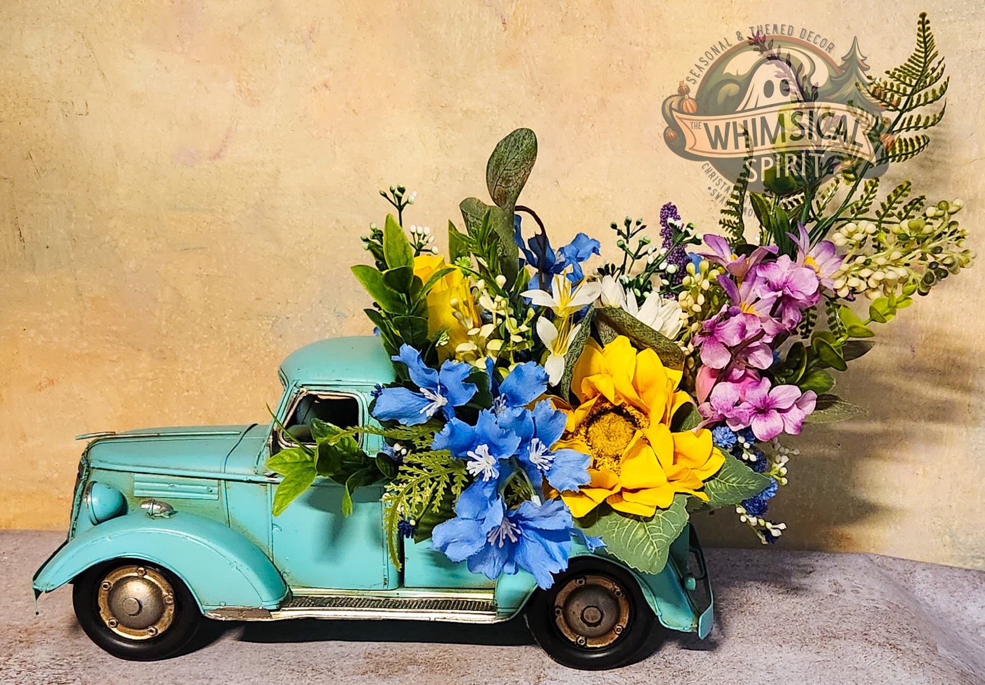Vintage toy truck with floral arrangement against a textured beige background