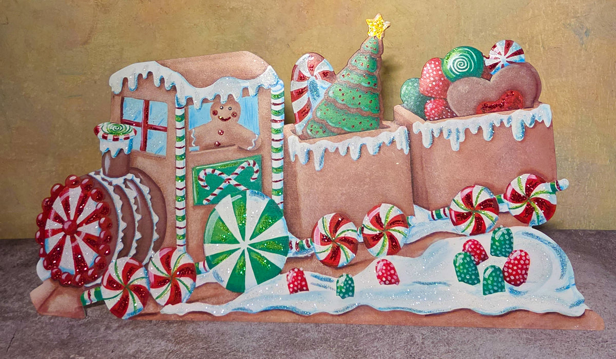 The Peppermint Express gingerbread Christmas train metal art featuring peppermint wheels, colorful candies, frosting details, and a smiling gingerbread conductor.