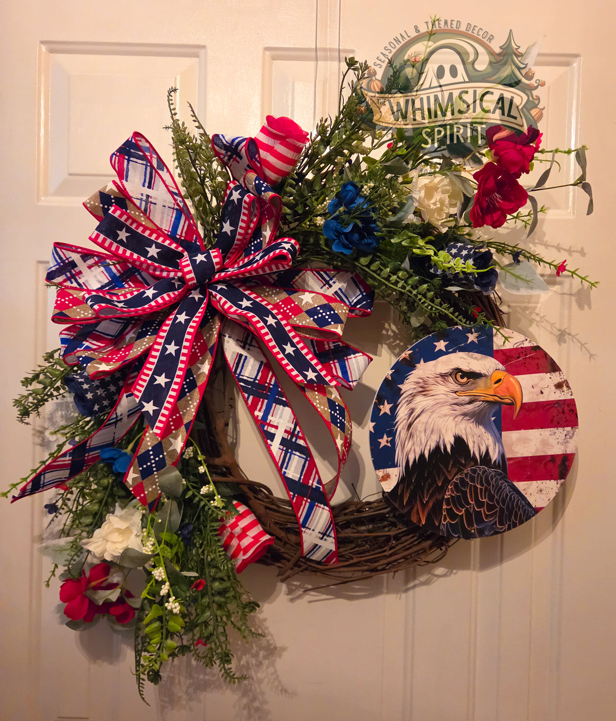 Decorative wreath with American flag elements and 'Whimsical Spirit' branding on a door.