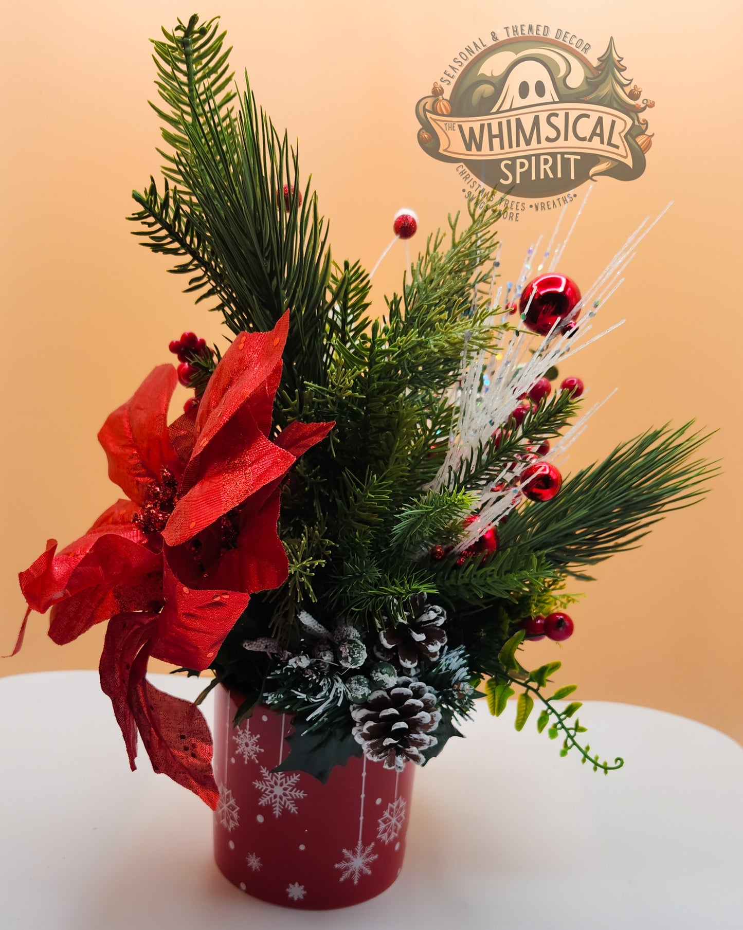 Christmas-themed floral arrangement in a christmas holiday mug .