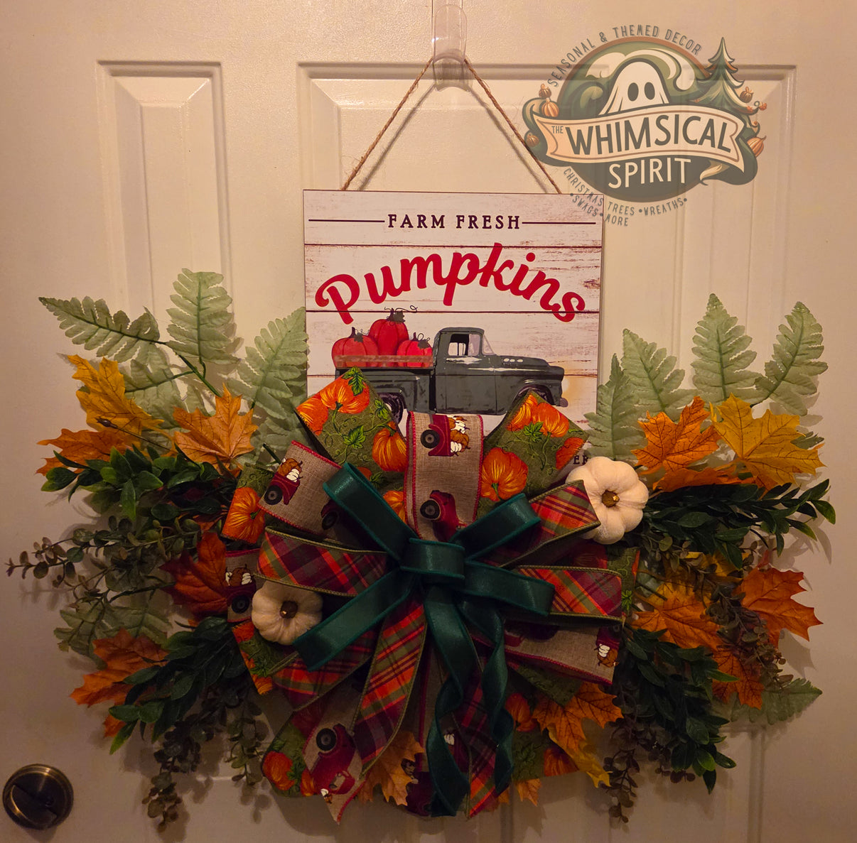 Fall Farm Fresh Pumpkins door hanger with vintage truck sign, autumn leaves, greenery, white pumpkin accents, and layered plaid bow.