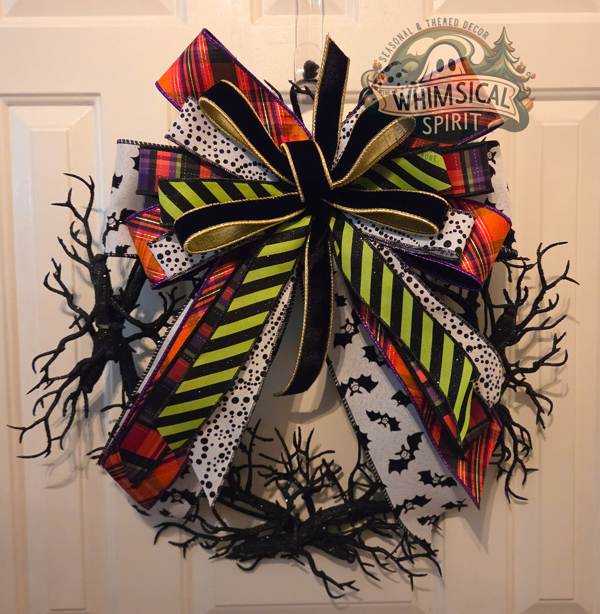 Bats & Stripes black twig Halloween wreath with an oversized plaid, lime-striped, bat-print, and velvet bow.