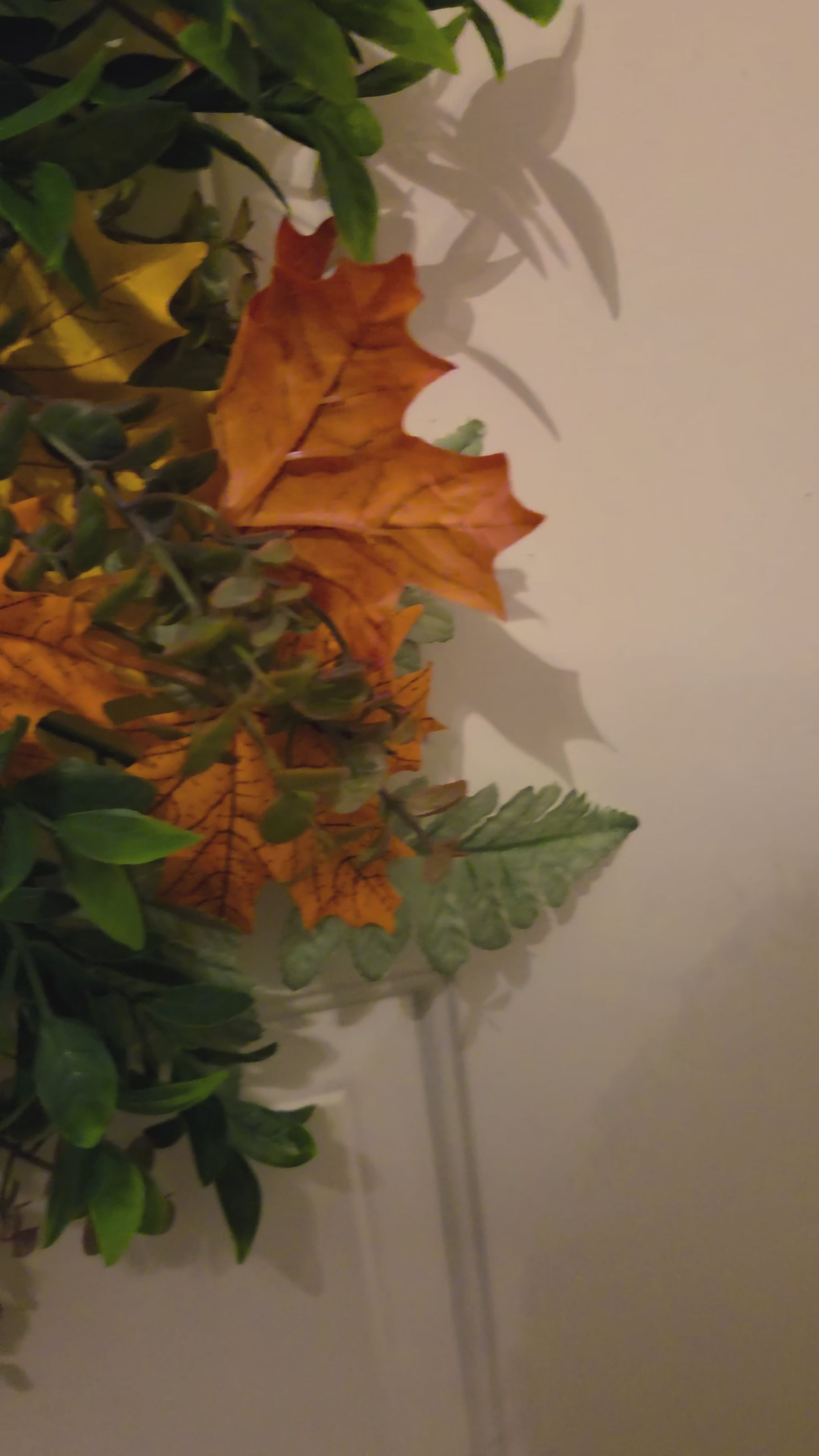 Closeup video of a handmade fall Farm Fresh Pumpkins door hanger, showing the vintage truck sign, layered plaid bow, white pumpkin accents, autumn leaves, and full finished design as the camera pans out.