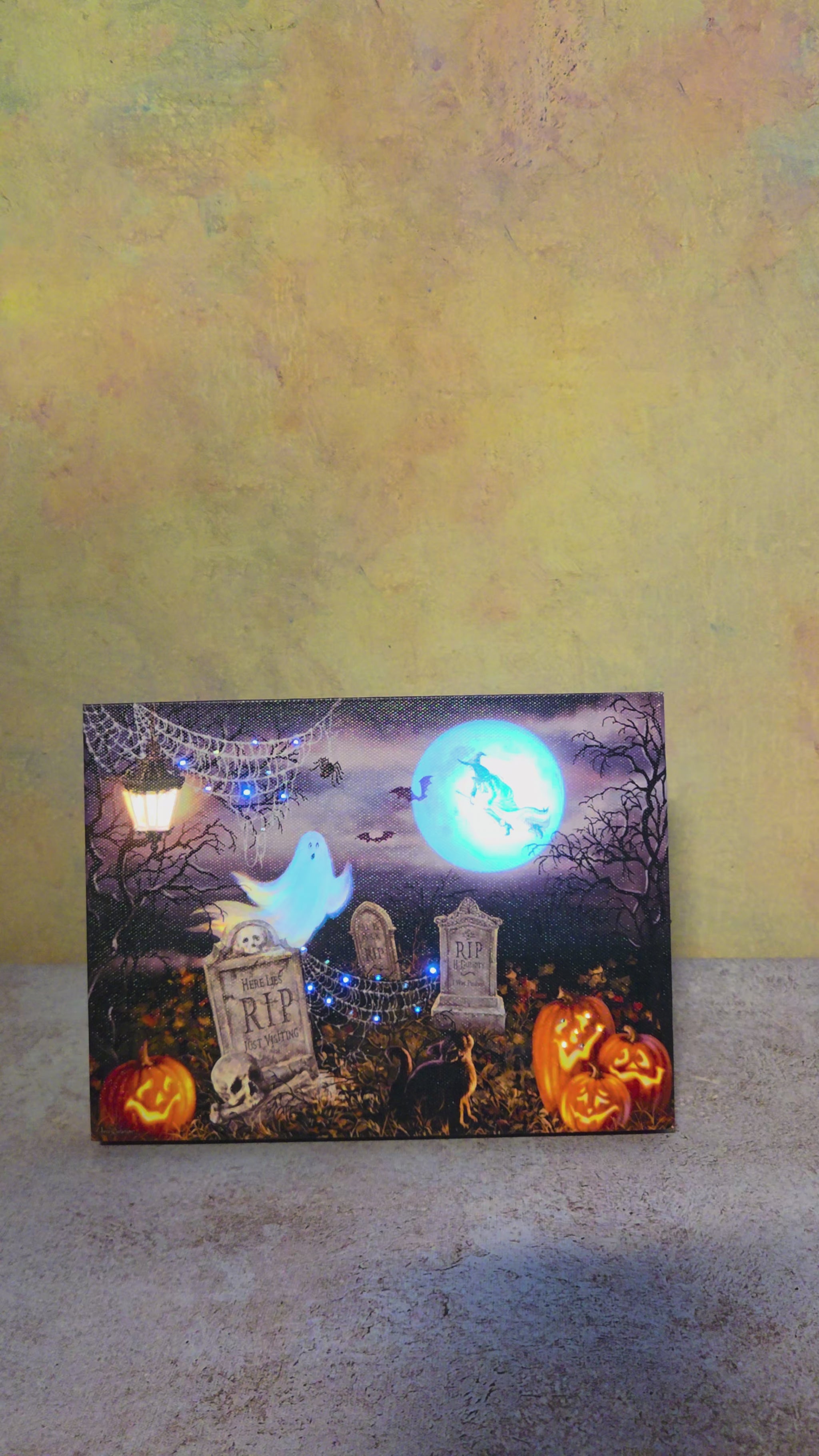Graveyard Glow Halloween canvas shown from multiple angles before its lights are switched on to reveal the illuminated cemetery scene.