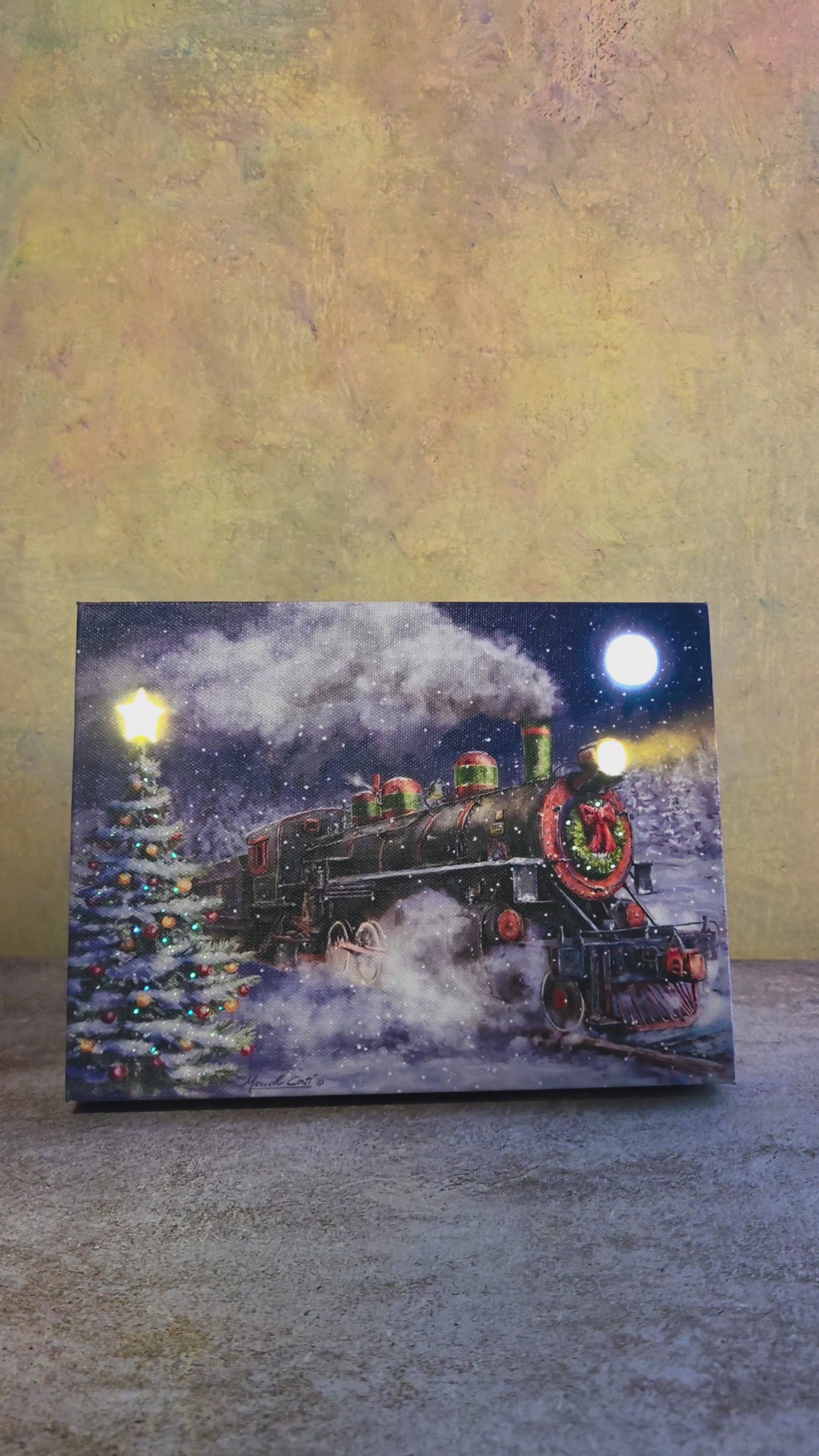 Video showing the light-up function on North Pole Express, a Christmas tabletop canvas featuring a festive holiday train, decorated Christmas tree, snowy tracks, full moon, and glowing winter details.