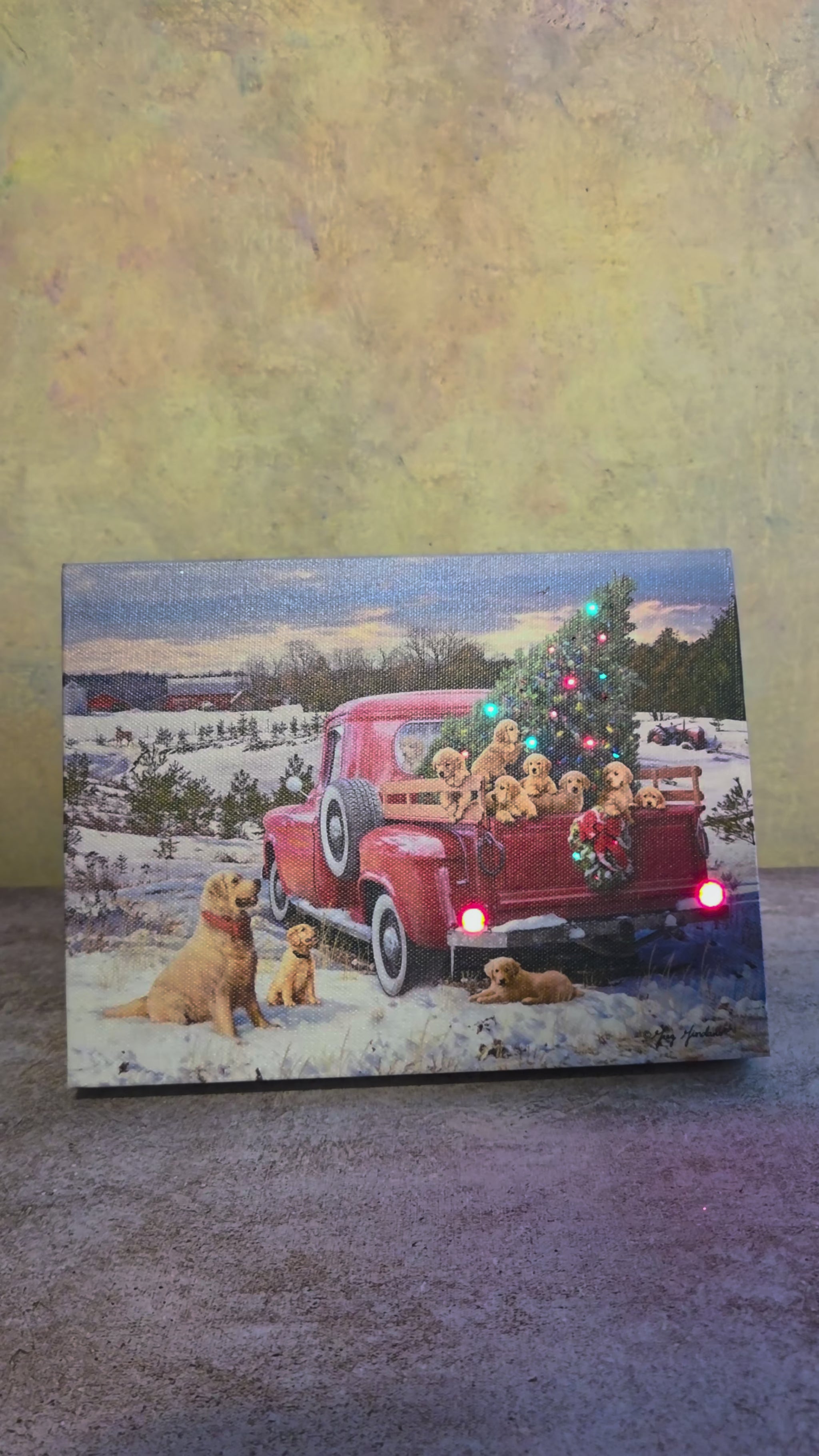 Video showing the light-up function on A Puppy Christmas, a holiday tabletop canvas featuring a red truck, Christmas tree, and golden puppies in a snowy winter scene.