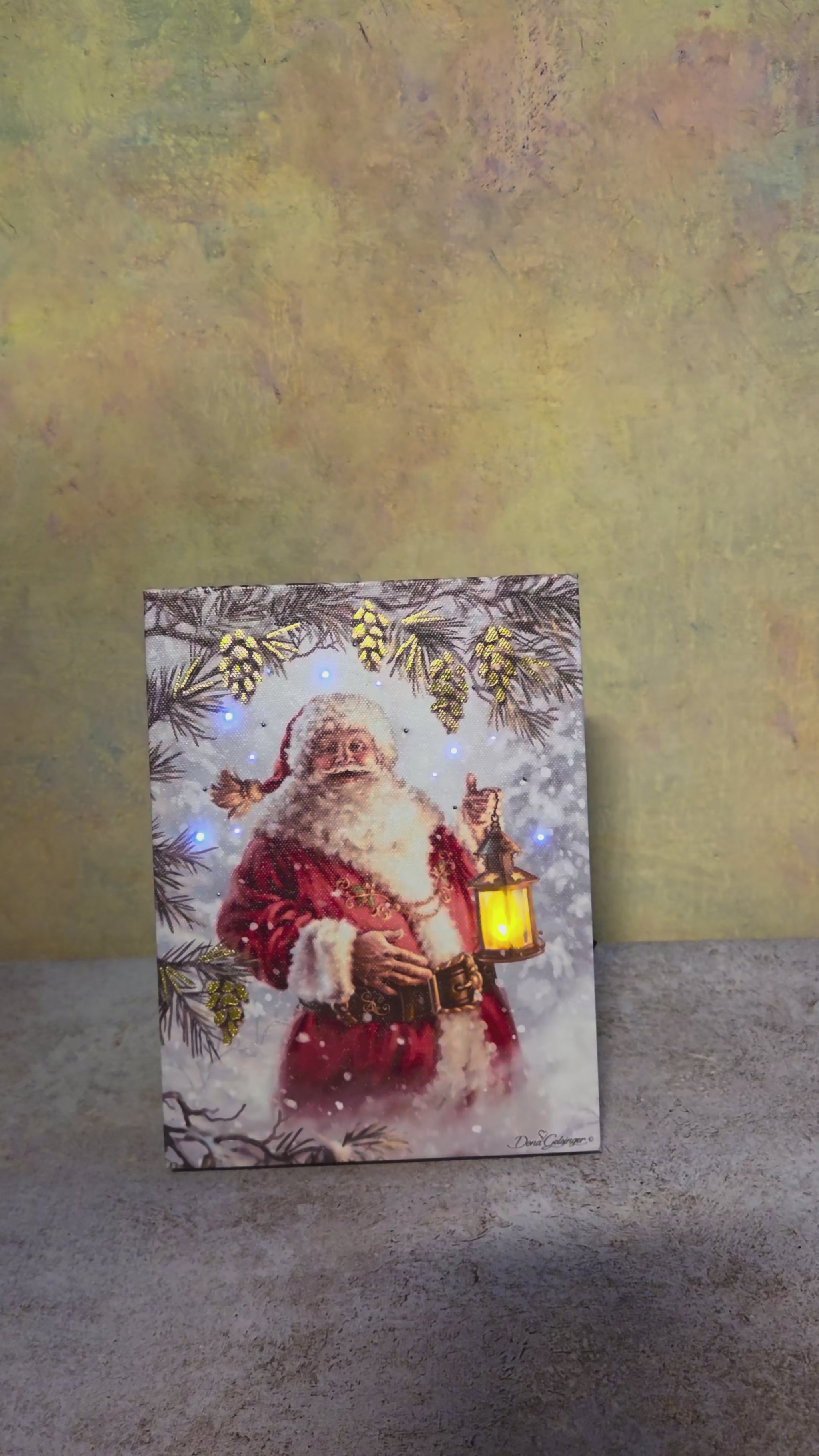 Santa’s Lantern Glow canvas shown from multiple angles before the lights are switched on to highlight the glowing lantern and illuminated pinecones.