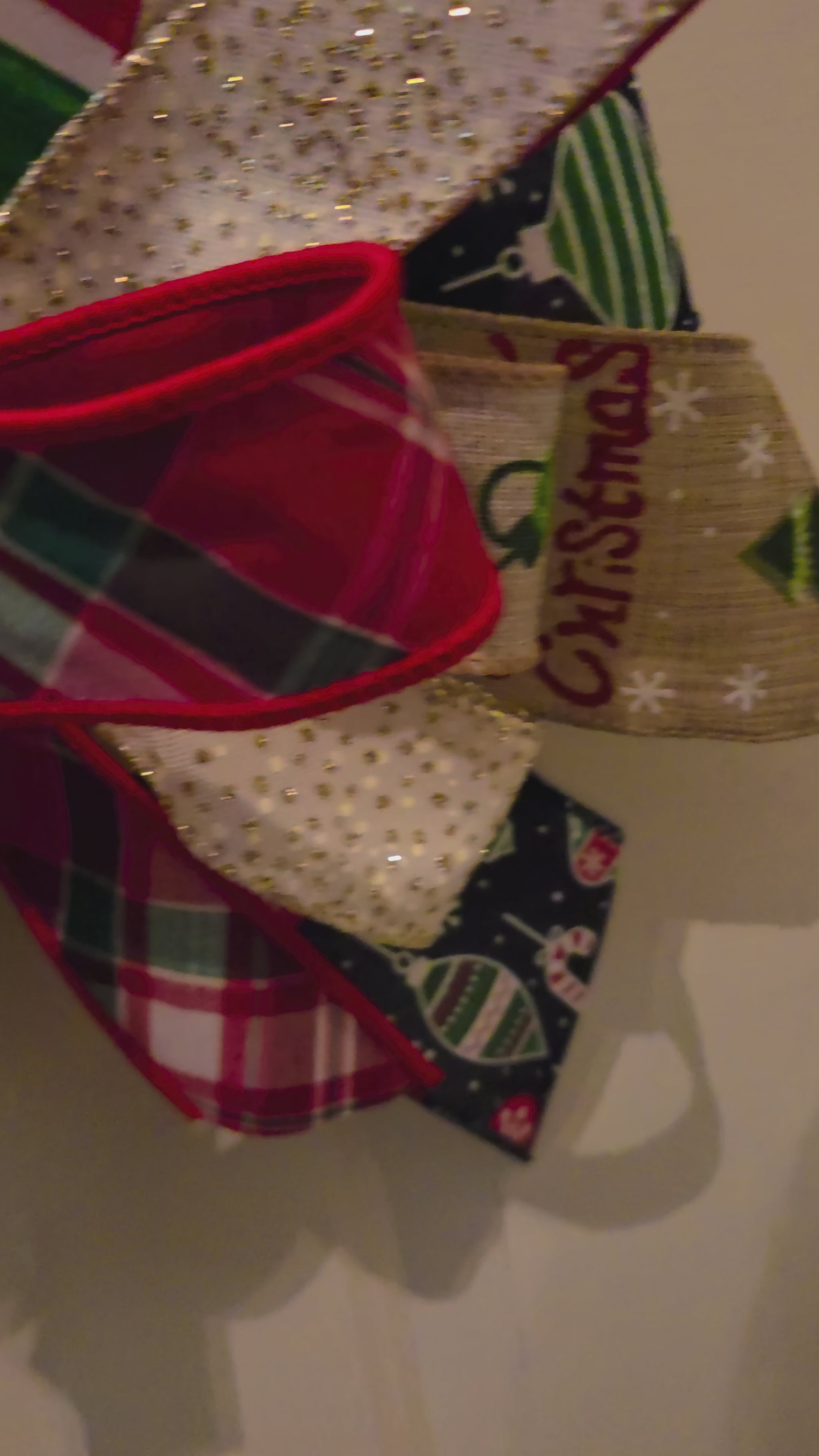 Video showing the details of the Baubles Full of Cheer stacked ornament door hanger, including the colorful ornament design and layered holiday bow.