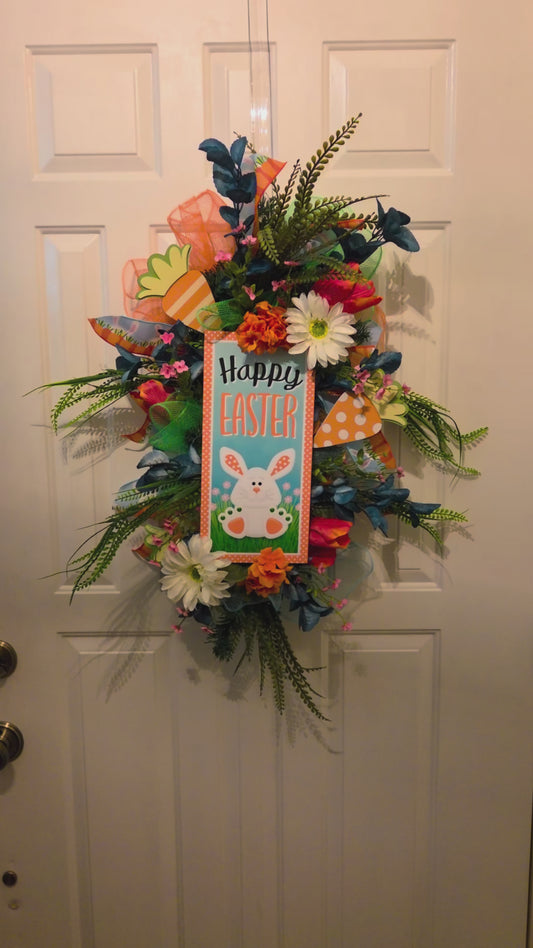 Video of Decorative wreath with flowers and a Happy Easter sign on a white door.